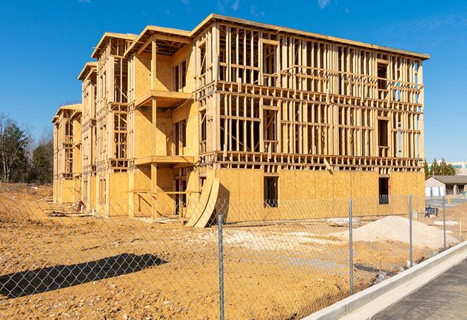 a construction site enclosed by temporary chain link fences, ensuring safety for workers and pedestrians in Orland Park IL